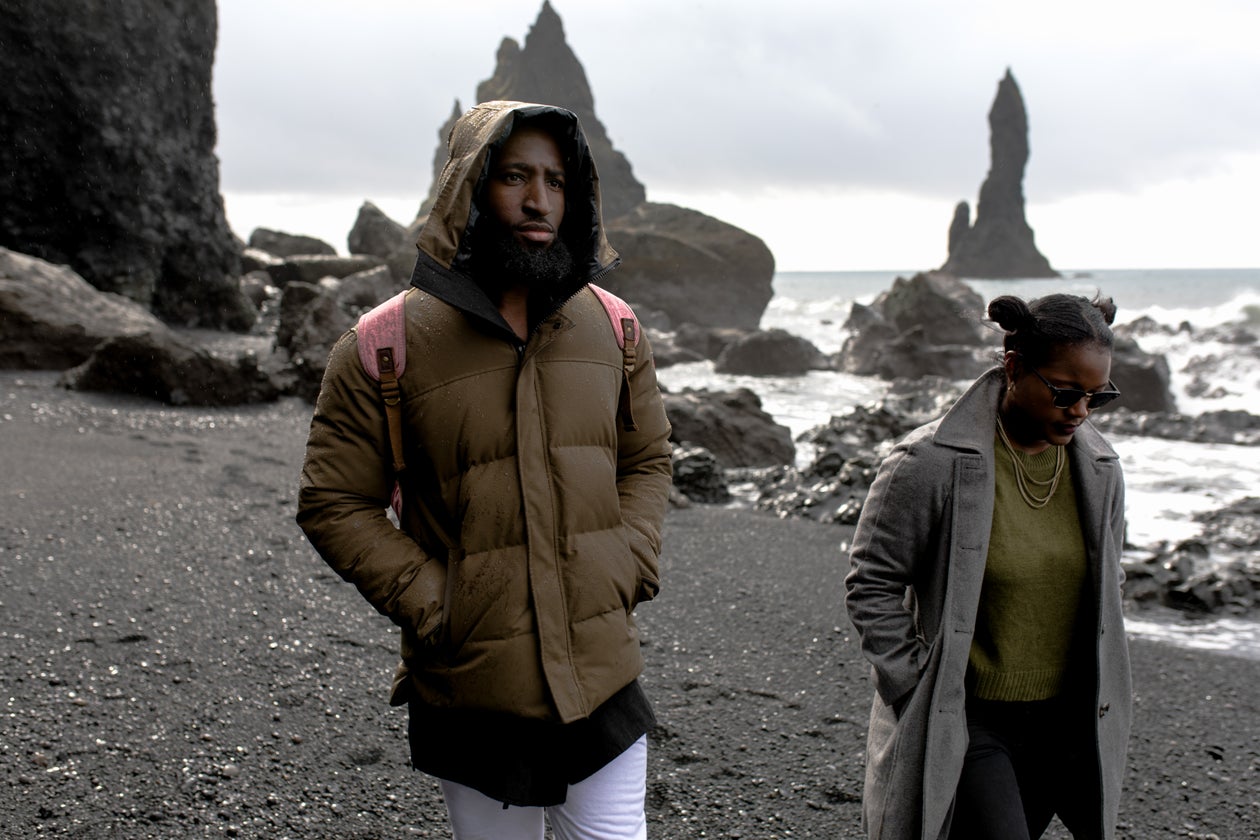 Two hikers with backpacks exploring dramatic rocky terrain together